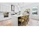 Bright kitchen features white cabinets, stainless steel appliances, and a large island with bar seating at 1171 State St # B, Atlanta, GA 30318