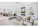 Bright open-concept living room with modern decor, a fireplace, and seamless flow to the kitchen at 1171 State St # B, Atlanta, GA 30318