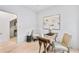 Spacious office with hardwood floors, featuring a vintage desk, armchairs, and modern artistic decorations at 1171 State St # B, Atlanta, GA 30318