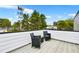 Relaxing rooftop deck featuring cozy outdoor seating with scenic neighborhood views and leafy tree tops at 1171 State St # B, Atlanta, GA 30318