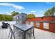 Aesthetic rooftop deck featuring outdoor kitchen area, modern seating, and a captivating skyline view at 1171 State St # B, Atlanta, GA 30318