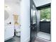 Bathroom featuring a black door to a deck area, a white vanity, and gold accents at 224 Ormond Sw St # A, Atlanta, GA 30315
