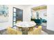 Open-concept dining area leading to a cozy living room with emerald green velvet furniture at 224 Ormond Sw St # A, Atlanta, GA 30315