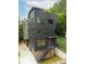 Modern exterior of home with black siding, stone foundation, and an elevated entrance with metal stairs at 224 Ormond Sw St # A, Atlanta, GA 30315