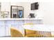 Kitchen area with a stainless steel refrigerator, white cabinetry, and island seating plus marble table at 224 Ormond Sw St # A, Atlanta, GA 30315