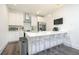 Bright kitchen with white cabinets, stainless steel appliances, island with bar stools, and hardwood floors at 224 Ormond Sw St # A, Atlanta, GA 30315