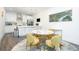 Open kitchen area with stainless steel appliances, island seating, a modern table set, and hardwood floors at 224 Ormond Sw St # A, Atlanta, GA 30315