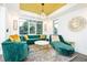 Bright living room featuring emerald green seating, a stylish light fixture, and large windows at 224 Ormond Sw St # A, Atlanta, GA 30315