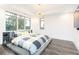 A spacious main bedroom features hardwood floors, abundant natural light, and modern lighting fixture at 224 Ormond Sw St # A, Atlanta, GA 30315