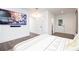 Bright main bedroom featuring a large TV, hardwood floors, and neutral decor at 224 Ormond Sw St # A, Atlanta, GA 30315