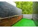 Exterior image shows a small side yard with faux grass and modern wood wall at 224 Ormond Sw St # A, Atlanta, GA 30315