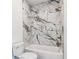 Beautiful tub and shower combo boasts stunning marble-look tile at 2312 Herring Sw Rd, Atlanta, GA 30311