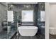 Luxurious bathroom featuring a modern soaking tub, glass-enclosed shower, and sleek fixtures at 2312 Herring Sw Rd, Atlanta, GA 30311