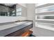 Modern bathroom with sleek vanity, decorative windows, and glass-enclosed shower at 2312 Herring Sw Rd, Atlanta, GA 30311