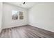 Bright bedroom with two windows, white walls, gray floors and a ceiling fan at 2312 Herring Sw Rd, Atlanta, GA 30311