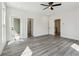 Bright, spacious bedroom with hardwood floors, ceiling fan, and abundant natural light at 2312 Herring Sw Rd, Atlanta, GA 30311