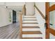 Inviting entryway featuring hardwood stairs, modern railings, and an open-concept living space at 2312 Herring Sw Rd, Atlanta, GA 30311