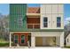 Modern two-story home featuring a covered front porch and a two-car garage at 2312 Herring Sw Rd, Atlanta, GA 30311