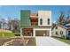 Modern two-story home featuring a unique, colorful facade and a convenient covered parking area at 2312 Herring Sw Rd, Atlanta, GA 30311