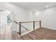 Hallway with white walls and wooden handrail, leading to bedrooms at 2312 Herring Sw Rd, Atlanta, GA 30311