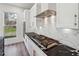 Stylish kitchen features a gas stove, marble backsplash, and stainless steel appliances at 2312 Herring Sw Rd, Atlanta, GA 30311