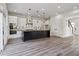 Modern kitchen featuring stainless appliances, a central island, and access to the staircase at 2312 Herring Sw Rd, Atlanta, GA 30311