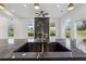Modern open-concept kitchen with a black countertop island and a view of the backyard at 2312 Herring Sw Rd, Atlanta, GA 30311