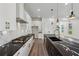 Contemporary kitchen boasts a marble backsplash, white cabinets, black countertops, and stainless steel appliances at 2312 Herring Sw Rd, Atlanta, GA 30311
