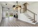 Expansive living room with hardwood floors, modern staircase, and abundant natural light at 2312 Herring Sw Rd, Atlanta, GA 30311
