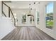 Open-concept living area with hardwood floors, modern lighting, and large windows at 2312 Herring Sw Rd, Atlanta, GA 30311