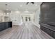 Bright living room with hardwood floors, fireplace, and open layout into the kitchen area at 2312 Herring Sw Rd, Atlanta, GA 30311