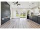 Bright living room with a modern fireplace, an open floorplan, hardwood floors and backyard access at 2312 Herring Sw Rd, Atlanta, GA 30311