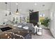 Open-concept living room featuring a modern fireplace, stylish furnishings, and seamless flow into the dining area at 2312 Herring Sw Rd, Atlanta, GA 30311