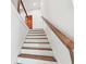 A modern staircase with wooden treads and a white railing at 2312 Herring Sw Rd, Atlanta, GA 30311