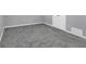 Finished basement area with plush gray carpeting and white trim throughout at 4564 Cypress Ridge Ct, Stone Mountain, GA 30083