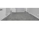 Finished basement with gray carpeting and white doors leading to other rooms at 4564 Cypress Ridge Ct, Stone Mountain, GA 30083