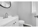 Powder room featuring a modern white vanity and a toilet for convenience at 4564 Cypress Ridge Ct, Stone Mountain, GA 30083