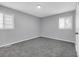 This bedroom has neutral walls and gray carpet, plus two windows for natural light at 4564 Cypress Ridge Ct, Stone Mountain, GA 30083