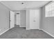 Bedroom with neutral walls and gray carpet. Double closet for extra storage at 4564 Cypress Ridge Ct, Stone Mountain, GA 30083