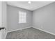 Bedroom featuring gray walls, neutral carpet, and natural light from the window at 4564 Cypress Ridge Ct, Stone Mountain, GA 30083