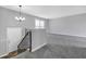 Bright, spacious living room with new carpeting and plenty of natural light from the window at 4564 Cypress Ridge Ct, Stone Mountain, GA 30083