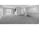 Bright, open-concept living room with new carpeting and sliding glass doors to the deck at 4564 Cypress Ridge Ct, Stone Mountain, GA 30083
