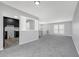 Open-concept living space with gray walls, plush carpeting, and ample natural light at 4564 Cypress Ridge Ct, Stone Mountain, GA 30083