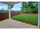 A spacious backyard includes a lush green lawn, wooden fence, and a concrete patio at 656 Avondale Park Cir, Decatur, GA 30032