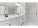 Elegant bathroom with double sinks, white cabinets, and marble flooring for a modern, clean aesthetic at 656 Avondale Park Cir, Decatur, GA 30032