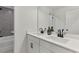Bathroom featuring double sinks, a large mirror, a bathtub and modern fixtures at 656 Avondale Park Cir, Decatur, GA 30032