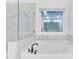 Luxurious bathroom featuring a soaking tub and a glass-enclosed shower with marble accents at 656 Avondale Park Cir, Decatur, GA 30032