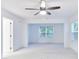 Large bedroom featuring plush carpeting, neutral walls, and a modern ceiling fan with a light at 656 Avondale Park Cir, Decatur, GA 30032