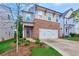 Charming two-story home featuring brick accents, a two-car garage, and a well-manicured lawn at 656 Avondale Park Cir, Decatur, GA 30032
