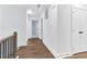 Bright hallway with hardwood floors, white walls, and modern doors leading to other rooms at 656 Avondale Park Cir, Decatur, GA 30032